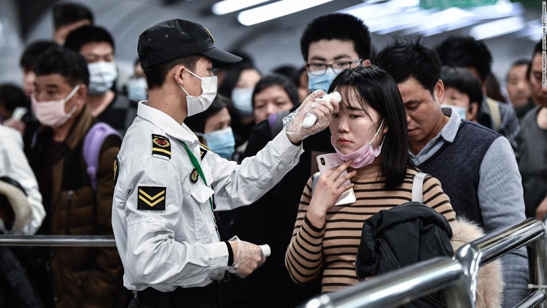 People go through a checkpoint in Guangzhou on January 22.