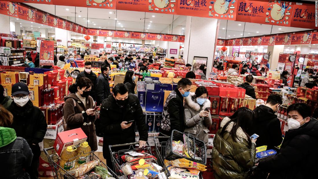 Shoppers wear masks in a Wuhan market on January 23, 2020.