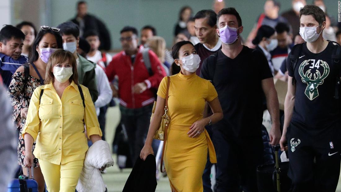 Passengers wear masks as they arrive at the Ninoy Aquino International Airport in Manila, Philippines, on January 23.