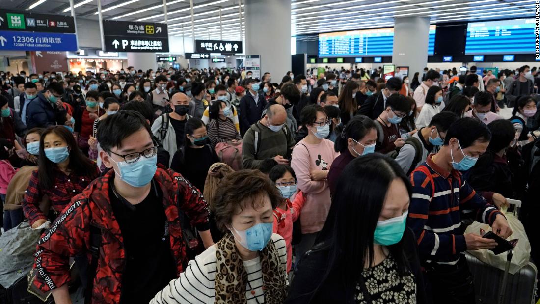 Passengers wear masks at a high-speed train station in Hong Kong on January 23, 2020.