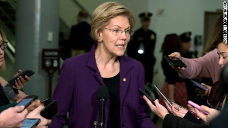 Sen. Elizabeth Warren,  talks to the media as she walks to the Senate chamber prior to the start of the impeachment trial. 