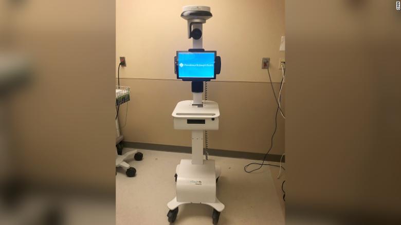 Doctors are using a robot to communicate with the man from outside the isolation area.