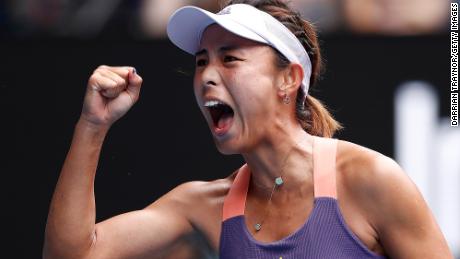 Qiang Wang of China celebrates after winning a point.