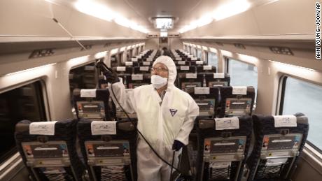 An employee sprays disinfectant on a train as a precaution against a new coronavirus at Suseo Station in Seoul, South Korea, Friday, Jan. 24, 2020. China broadened its unprecedented, open-ended lockdowns to encompass around 25 million people Friday to try to contain a deadly new virus that has sickened hundreds, though the measures&#39; potential for success is uncertain. (AP Photo/Ahn Young-joon)