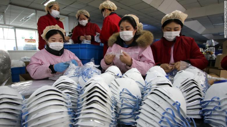 Workers manufacture protective face masks in a factory in China's Hebei Province on Thursday, January 23. Face masks stocks are running low following the outbreak of coronavirus.