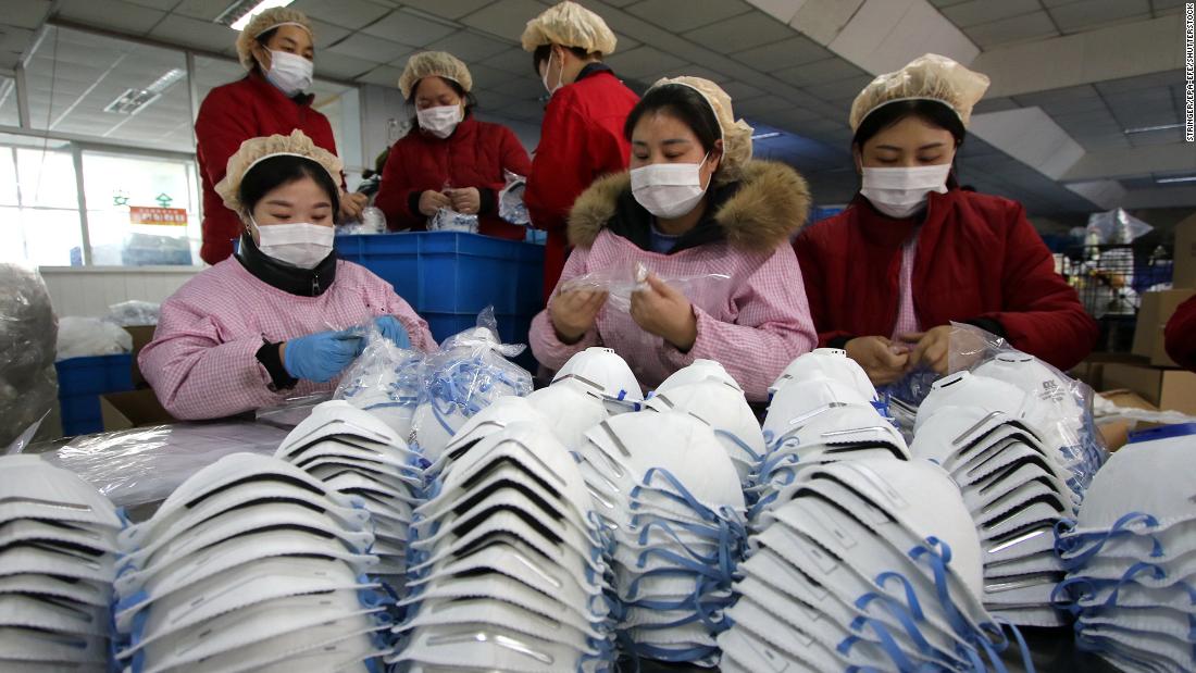 Workers manufacture protective face masks at a factory in China&#39;s Hubei Province on January 23, 2020.