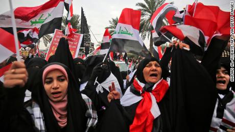 Women shout slogans at the protest in Baghdad against the US military presence in Iraq. 
