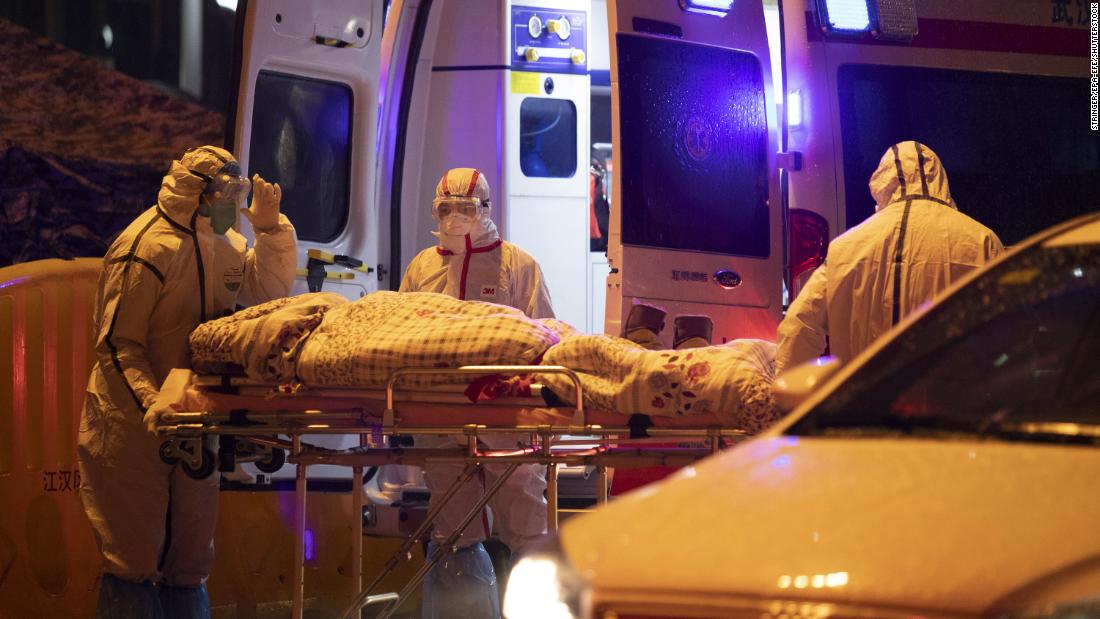 Medical staff members transfer a patient in Wuhan on January 23.