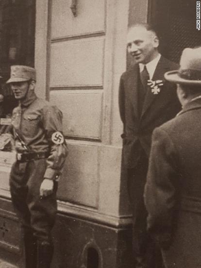 The notorious 1933 image shows Richard Stern, center, wearing his Iron Cross while a young Nazi guards the store.