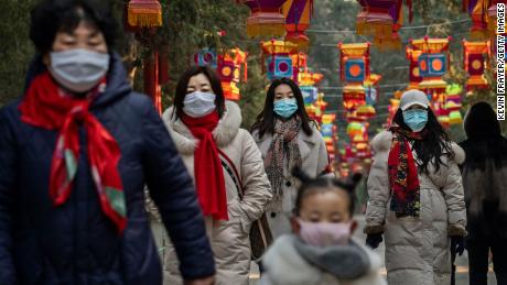 People wear protective masks during decorations marking  the Chinese New Year.
