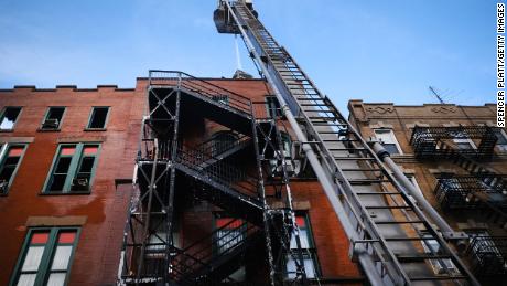 Firefighters continue to work in New York&#39;s Chinatown on Friday after a fire Thursday evening severely damaged a historic building that has been home to a museum, a senior center and other nonprofits for decades.