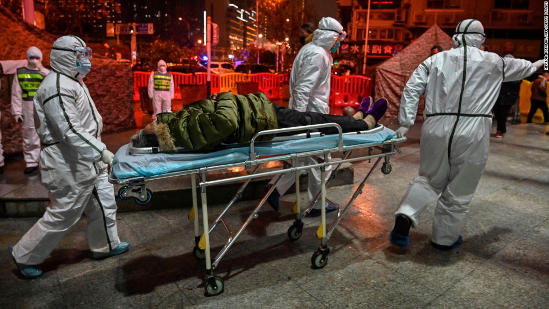 Medical staff members bring a patient to the Wuhan Red Cross hospital on January 25, 2020.