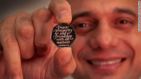Sajid Javid unveils the Brexit coin, bearing the inscription &quot;Peace, prosperity and friendship with all nations.&quot;