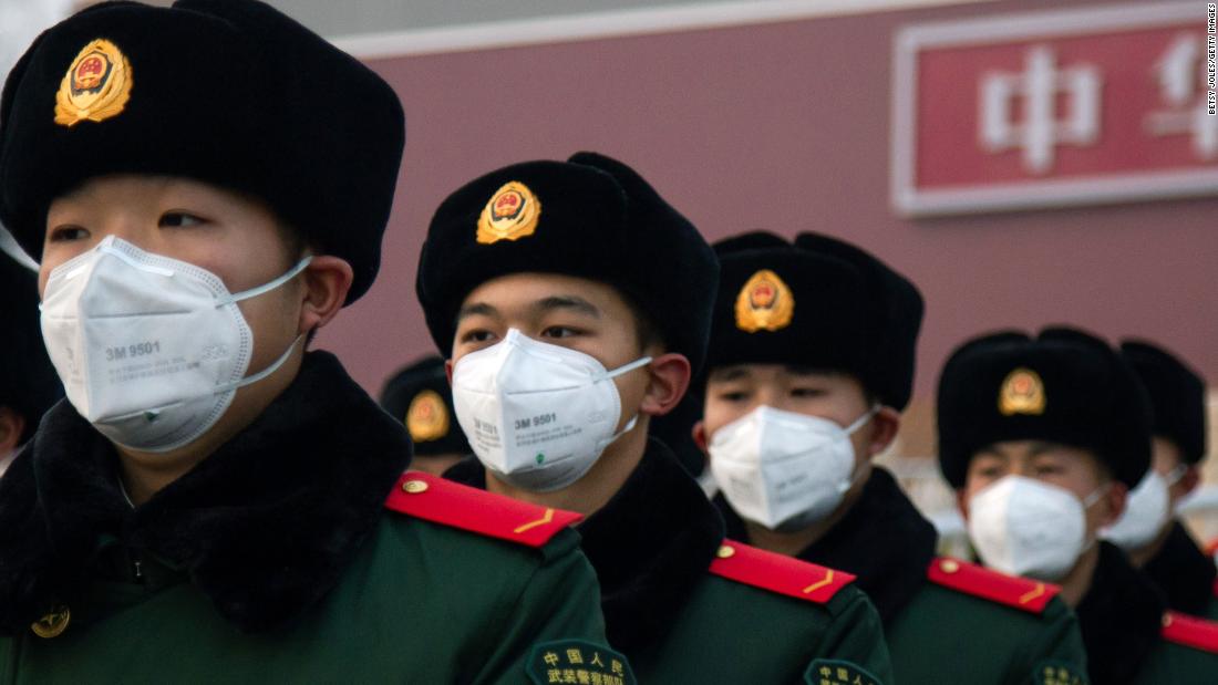 Police officers stand in front of the Tiananmen Gate in Beijing on January 26.