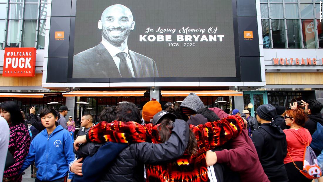 Fans mourn in front of Bryant&#39;s image across from Staples Center on Sunday.
