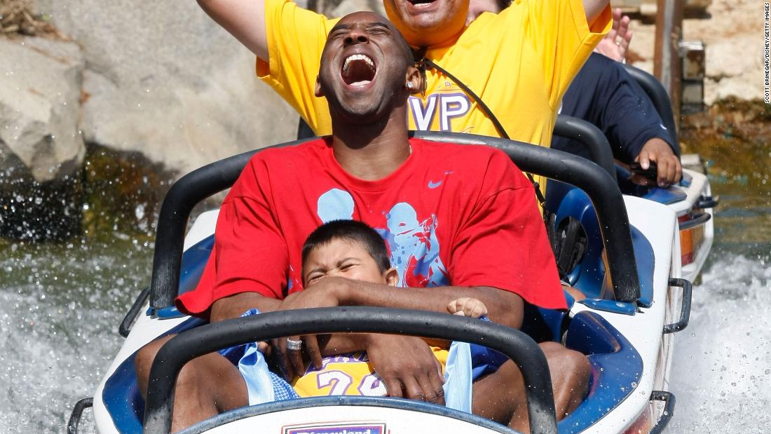 Bryant rides the Matterhorn Bobsleds with Jonathan Guerrero, 4, and his father, David Guerrero of Pomona, California, at Disneyland in Anaheim, California, in 2009. The Guerreros were among thousands of Lakers fans who turned out for a special Disneyland parade honoring the Lakers&#39; 15th World Championship.
