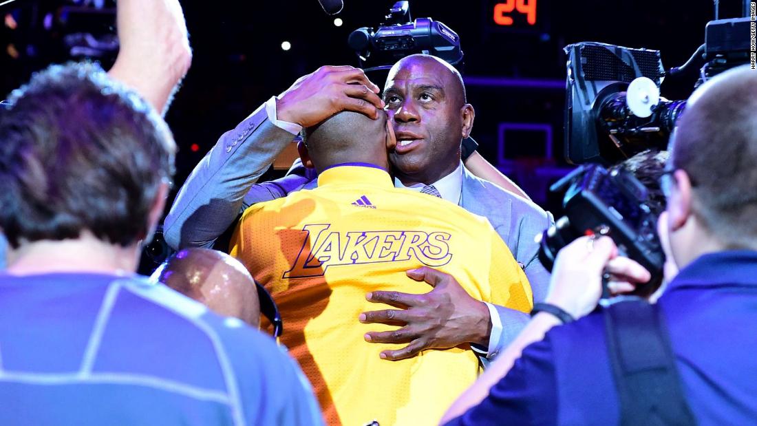 Magic Johnson hugs Bryant before the final game of his career in 2016.