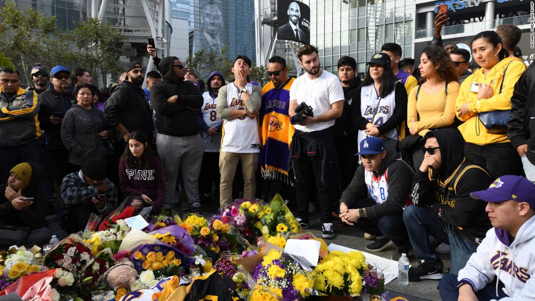 People gather at a memorial for Kobe Bryant near the Staples Center in Los Angeles on Sunday.