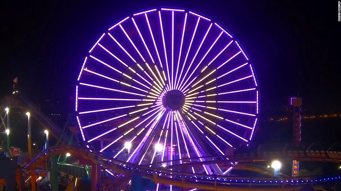 The Pacific Park Ferris wheel at the Santa Monica Pier is lit up purple and gold with Kobe Bryant&#39;s number 24 in Los Angeles on January 26.