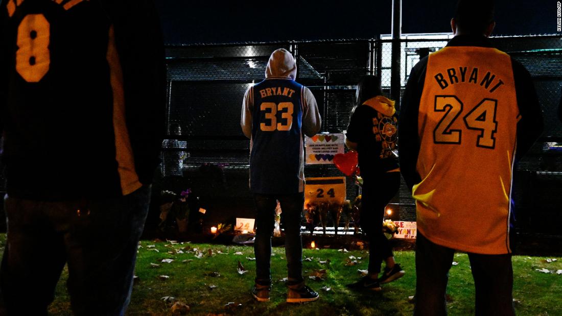 People gather near a small memorial outside of a basketball court in Calabasas, California, on January 26.