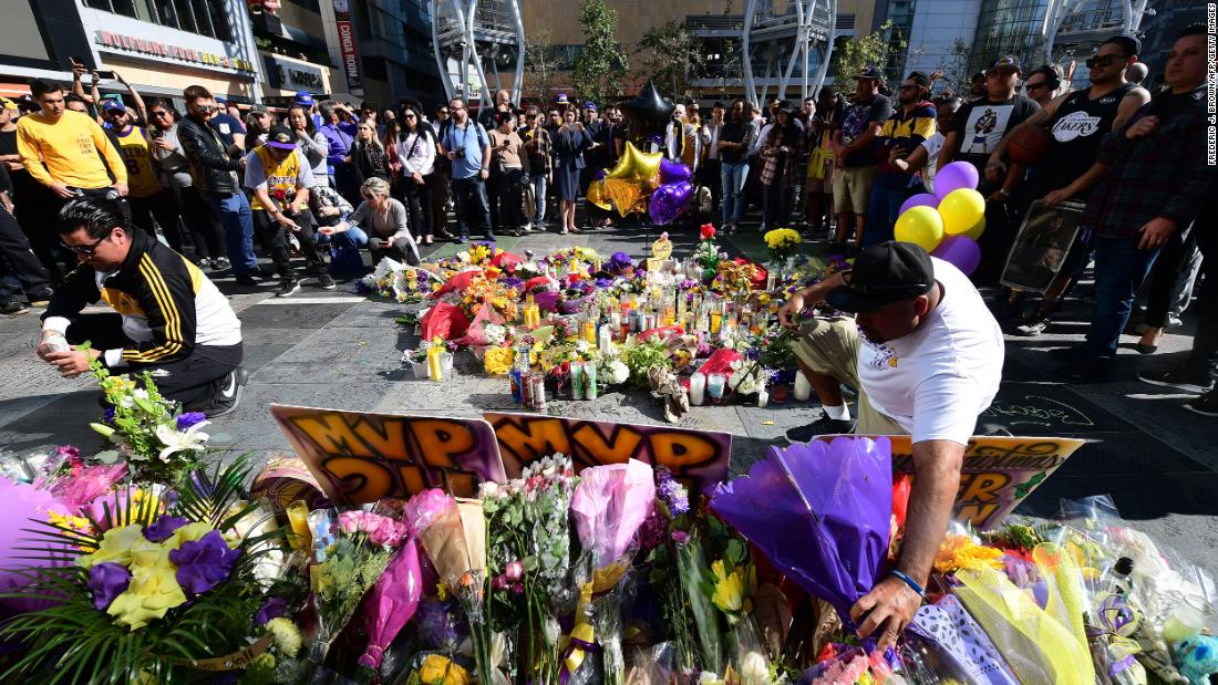 Fans place flowers at a makeshift memorial outside of the Staples Center in Los Angeles on January 27.
