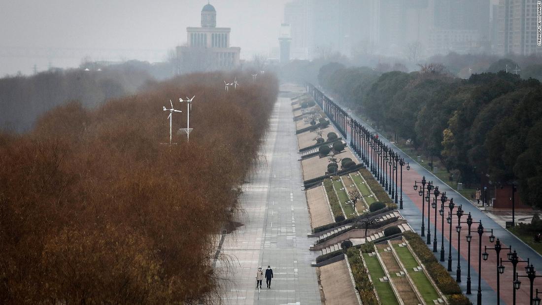 Two residents walk through the empty Jiangtan park on January 2 in Wuhan, at the center of the outbreak.