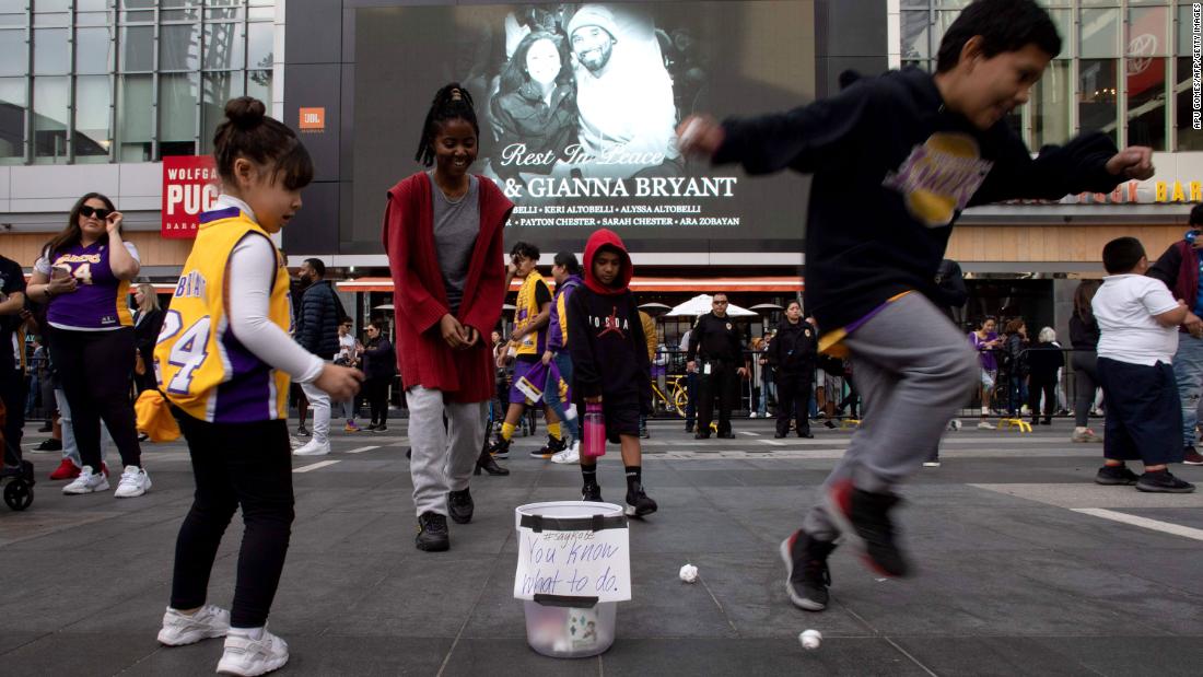 Children play with paper balls and a trash can in front of a makeshift memorial on January 27. A group of &lt;a href=&quot;https://www.cnn.com/2020/01/28/us/jumpshot-kobe-bryant-la-tribute-trnd/index.html&quot; target=&quot;_blank&quot;&gt;fans gathered at the LA Live Plaza&lt;/a&gt; and took turns shooting paper balls into the trash can while yelling &quot;Kobe,&quot; a gesture practiced in classrooms and offices across America.