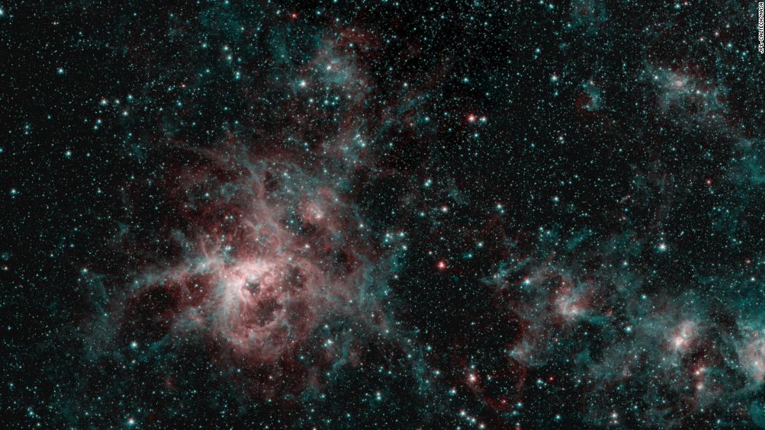 NASA&#39;s Spitzer Space Telescope captured the Tarantula Nebula in two wavelengths of infrared light. The red represents hot gas, while the blue regions are interstellar dust.