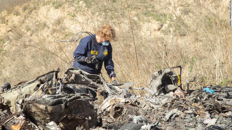 The NTSB's Carol Hogan examines wreckage at the crash site.