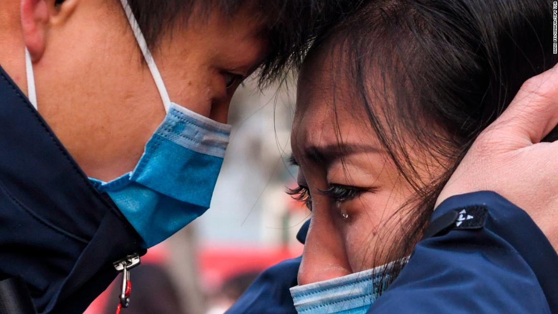 Lyu Jun, left, a member of a medical team leaving for Wuhan, says goodbye to a loved one in Urumqi, China, on January 28, 2020.