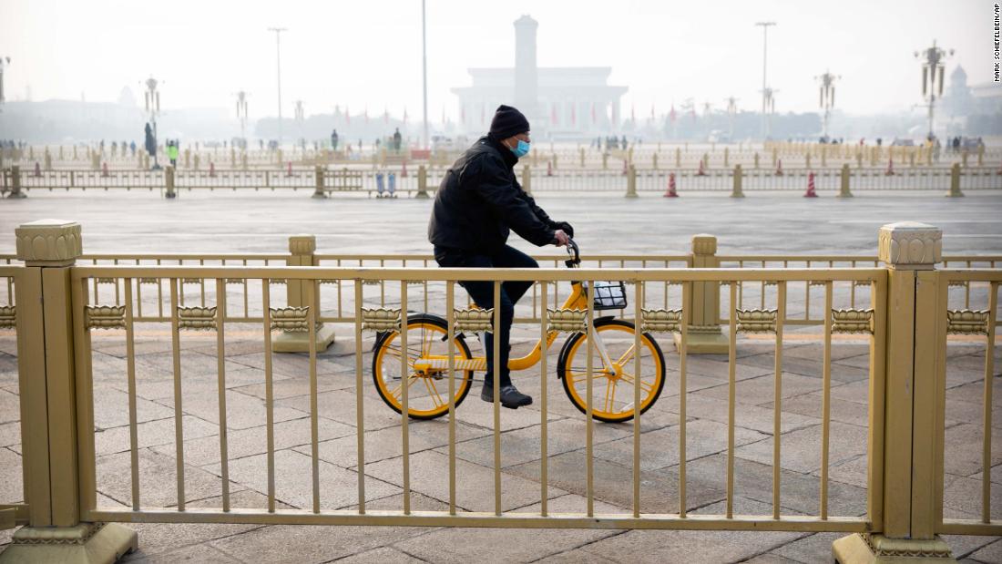 A cyclist rides past Beijing&#39;s Tiananmen Square, normally crowded with tourists during the Lunar New Year holiday, on January 27.