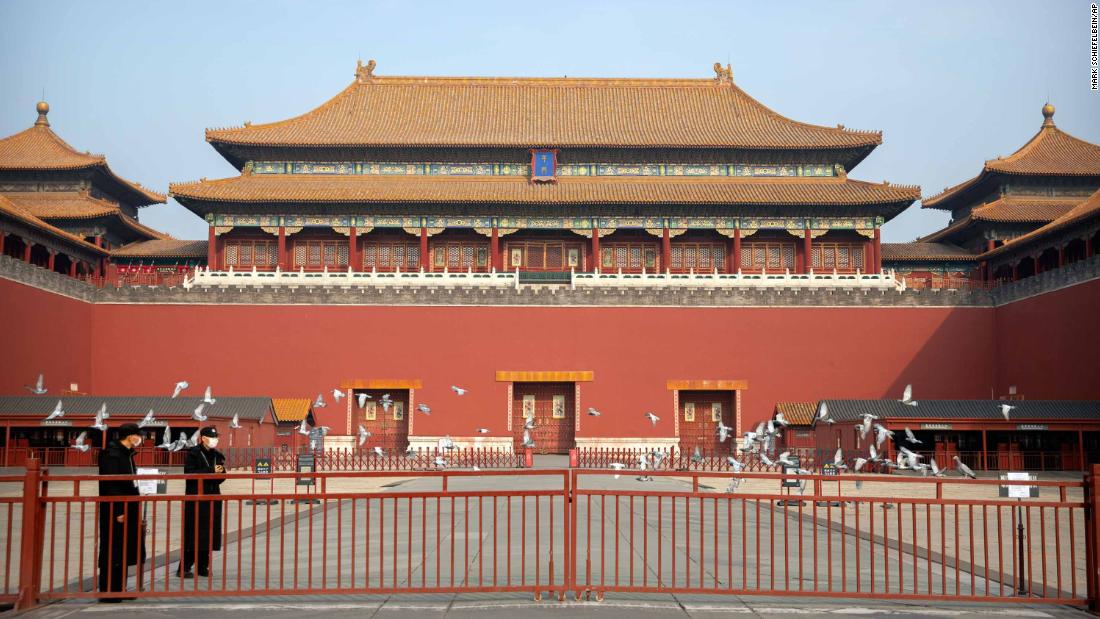 Security officials stand near the closed gates at the entrance to the Forbidden City. Cultural landmarks have closed their doors to visitors due to the outbreak.