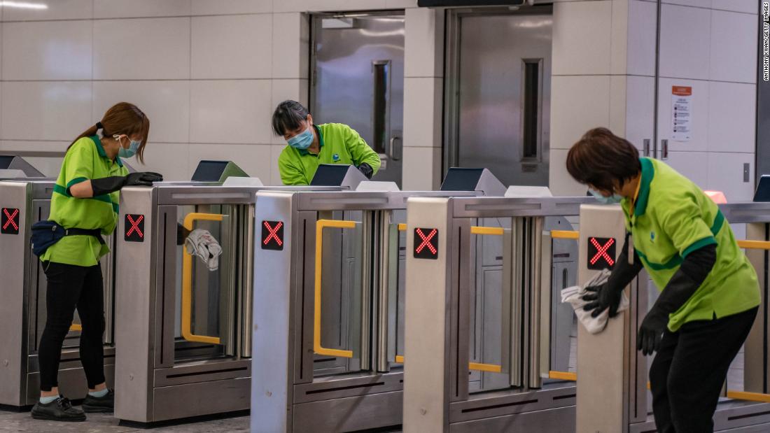 Workers clean a gate at Hong Kong&#39;s High Speed Rail Station on January 29. The city&#39;s government announced it will deny entry for travelers who has been to China&#39;s Hubei province, the epicenter of the outbreak, except for local residents. Hong Kong has also closed many of its border crossings with mainland China, amid calls from residents for more stringent measures.