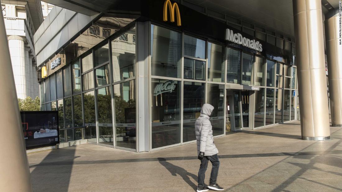A pedestrian passes a closed McDonald&#39;s restaurant in Shanghai on January 30.