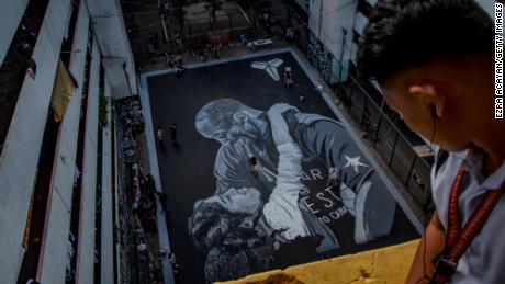A giant mural of former NBA star Kobe Bryant and his daughter Gianna, painted hours after their death, is seen at a basketball court on January 28, 2020 in Taguig, Metro Manila, Philippines. 