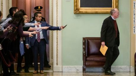 Reporters try to get a statement from Sen. Lamar Alexander (R-TN) as he passes by during a recess in the Senate impeachment trial of President Donald Trump on January 30, 2020.