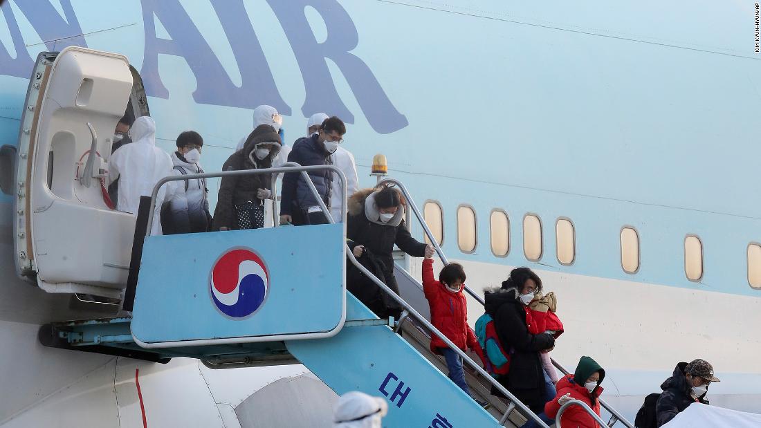 South Koreans evacuated from Wuhan disembark from a chartered flight at Gimpo Airport in Seoul, South Korea, on Friday, January 31.