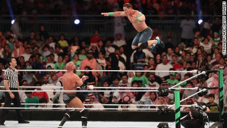 WWE Superstars John Cena (R) and Triple H.