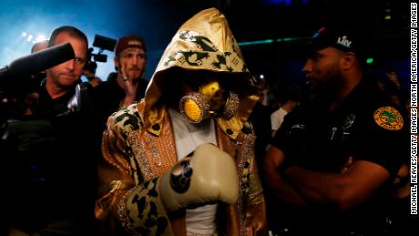 Jake Paul entered the ring wearing a custom Louis Vuitton-branded robe and gas mask.