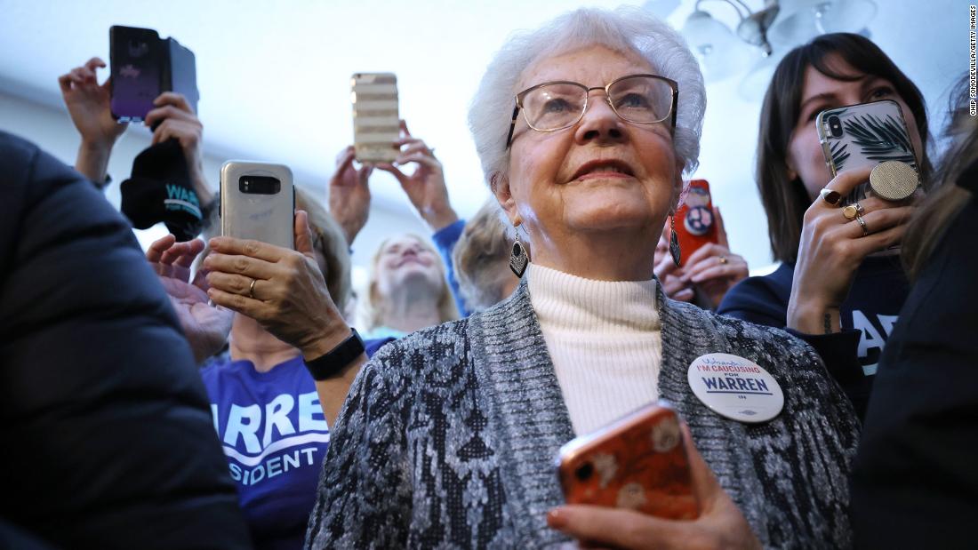 Campaign volunteers listen to Warren before going out to canvass voters in Urbandale, Iowa, on February 1.