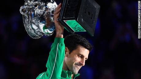 Serbia&#39;s Novak Djokovic holds up the Norman Brooks Challenge Cup trophy following his victory against Austria&#39;s Dominic Thiem in their men&#39;s singles final match on day fourteen of the Australian Open tennis tournament in Melbourne early on February 3, 2020. (Photo by William WEST / AFP) / IMAGE RESTRICTED TO EDITORIAL USE - STRICTLY NO COMMERCIAL USE (Photo by WILLIAM WEST/AFP via Getty Images)