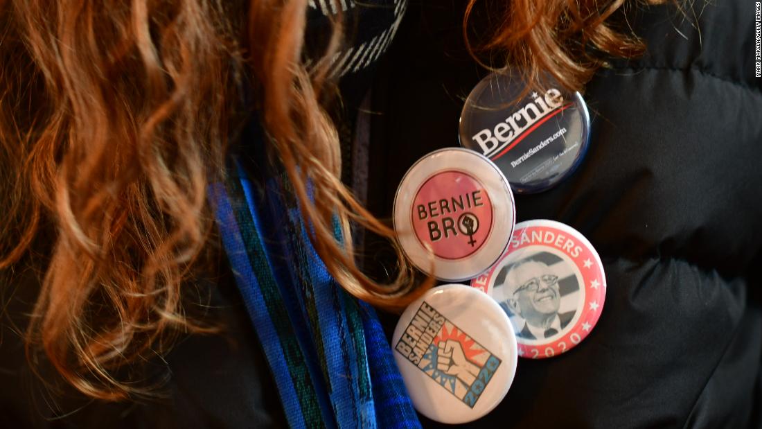 A volunteer wears Sanders campaign pins during an event in Waterloo on February 1.