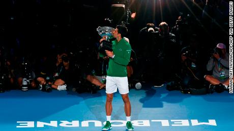 Novak Djokovic kisses the trophy after winning the Australian Open. 
