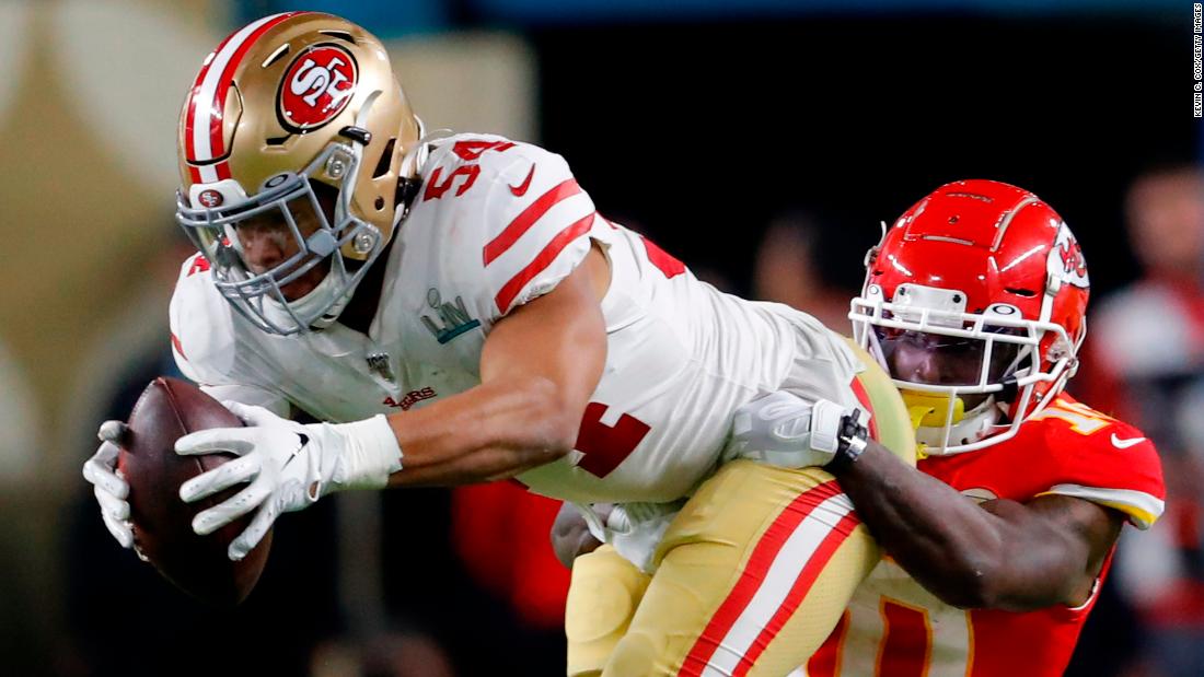 Warner is tackled by Tyreek Hill after his interception.