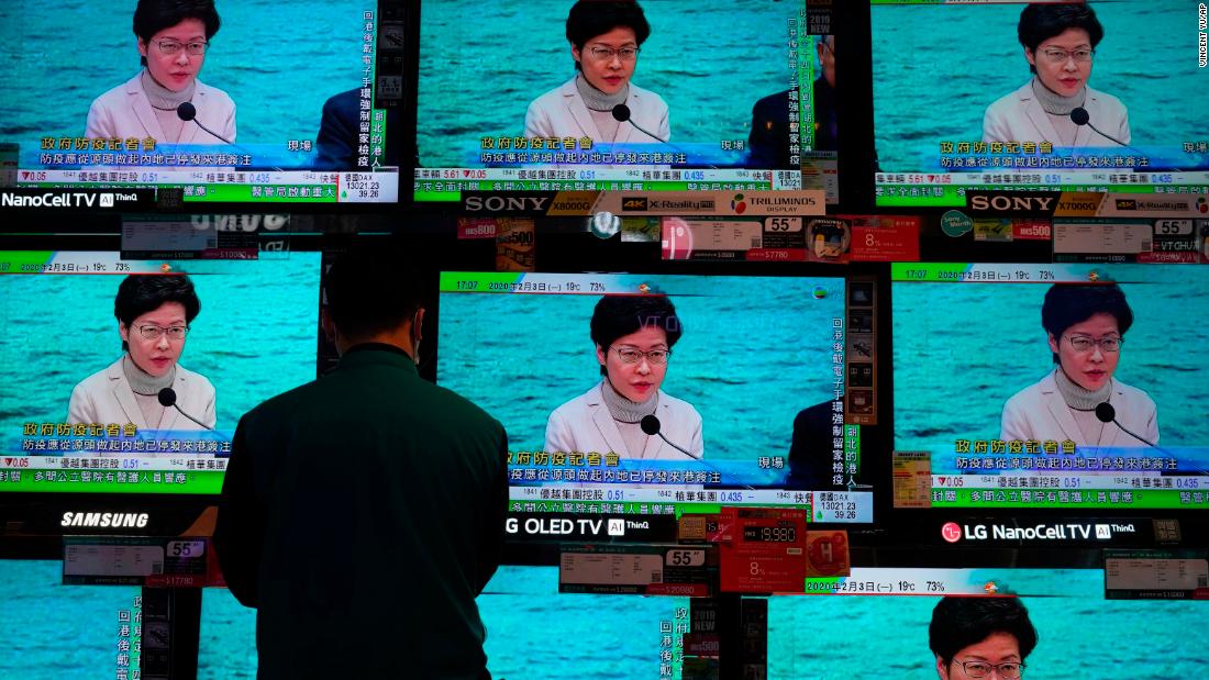 A man stands in front of TV screens broadcasting a speech by Hong Kong Chief Executive Carrie Lam on February 3, 2020. Lam said the city would shut almost all border-control points to the mainland.