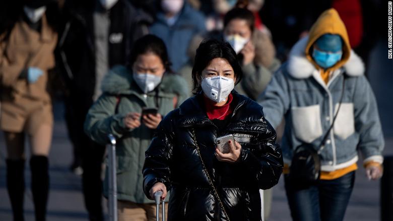 Travelers wearing facemasks arrive from various provinces at the Beijing Railway Station on February 3, 2020. - China said February 3 it urgently needed medical equipment and surgical masks as the death toll from a new coronavirus jumped above 360, making it more deadly than the SARS crisis nearly two decades ago. (Photo by NOEL CELIS/AFP via Getty Images)