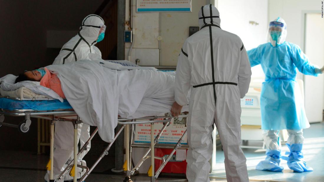 Medical workers move a coronavirus patient into an isolation ward at the Second People&#39;s Hospital in Fuyang, China, on February 1, 2020.