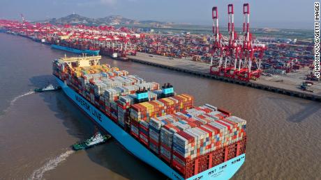 Tugboats guide a Maersk container ship at the Yangshan Deepwater Port, Shanghai. 