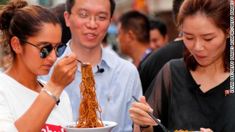 Sania Mirza of India and Li Na of China taste Wuhan noodles on September 25, 2017. 