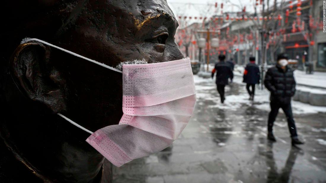 A mask is seen on a statue in Beijing on February 5, 2020.